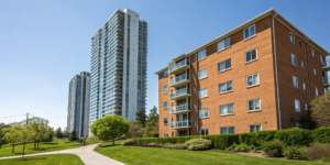 A condo building next to an apartment complex, comparing the choice of buying vs renting.